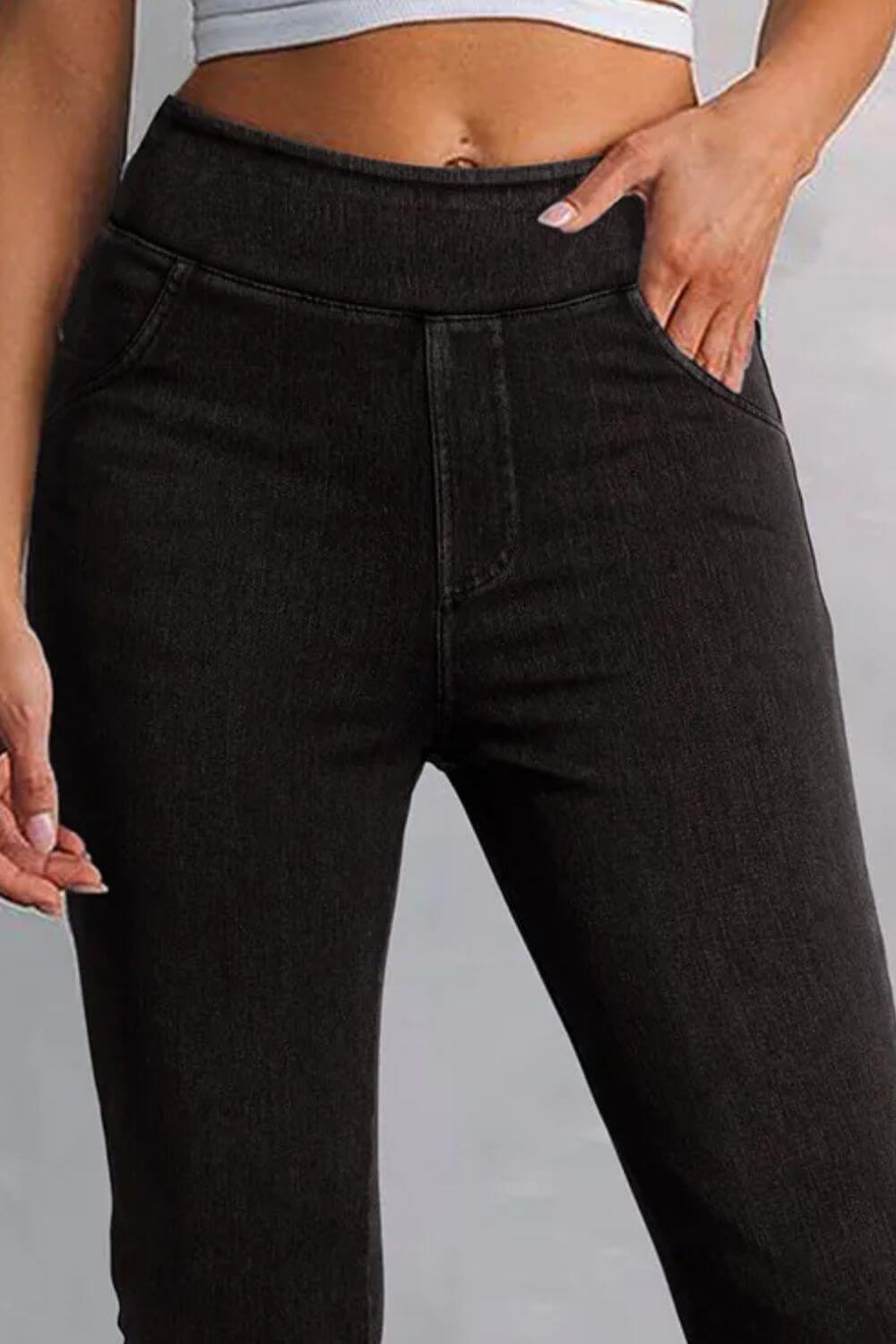 Petite black skinny jeans with pockets, moderate stretch material, flattering fit, made from polyester, cotton, and elastane.