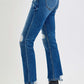 Risen high rise distressed crop straight jeans paired with sleek black ankle boots for a chic and edgy look.