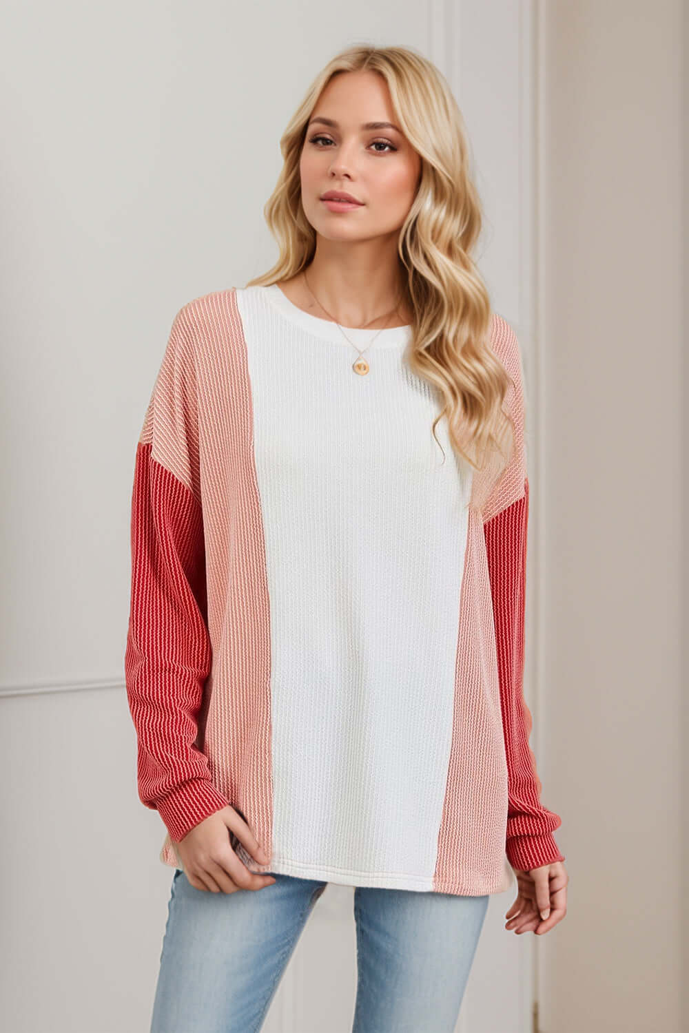 Woman wearing Double Take Texture Contrast Round Neck Long Sleeve T-Shirt in trendy color combo. Fashionable casual style.