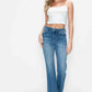 Model showcasing bytos Cat's Whiskers Mid Rise Bootcut Jeans, paired with a white crop top for a stylish look.