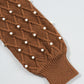 Bella Road sweater sleeve with pearl details and diamond knit pattern, featuring a ribbed cuff in rich brown color.