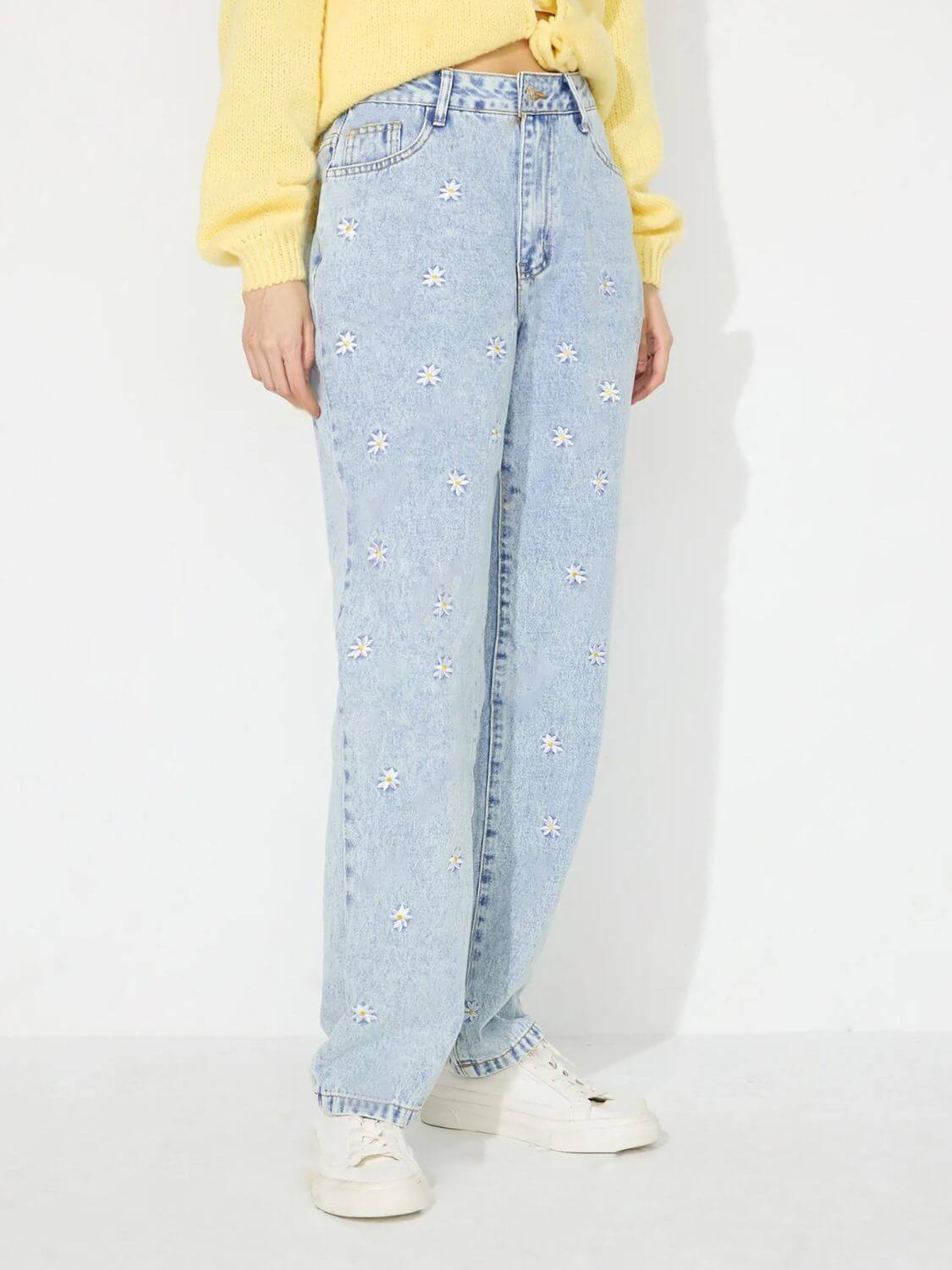 Bella Road Daisy Straight Jeans with Pockets, blue denim, white daisy print, straight leg fit, worn with yellow sweater and white sneakers