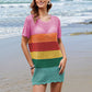 Fun beach cover-up featuring rainbow stripes and a round neck design, perfect for summer style and comfort by the ocean.