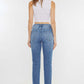 Woman wearing Cat's Whiskers High Waist Jeans showcasing flattering silhouette from the back.