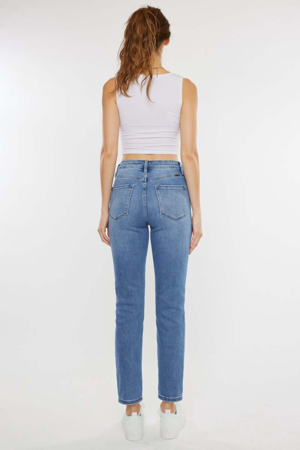 Woman wearing Cat's Whiskers High Waist Jeans showcasing flattering silhouette from the back.