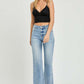 Woman wearing RISEN full size high rise straight jeans and black crop top, showcasing chic and timeless denim fashion.