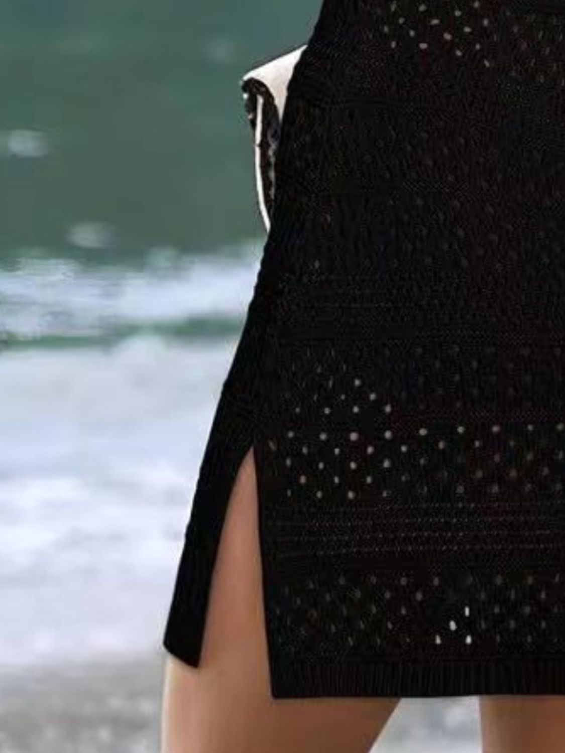 Semi-sheer black openwork cover up with side slit, perfect for stylish beach days and sunny adventures.