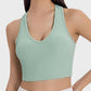 Model wearing a mint green Millennia Scoop Neck Wide Strap Active Tank, showcasing its stylish and comfortable design.