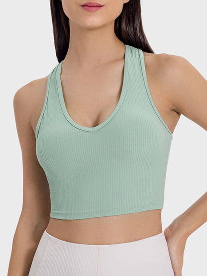 Model wearing a mint green Millennia Scoop Neck Wide Strap Active Tank, showcasing its stylish and comfortable design.