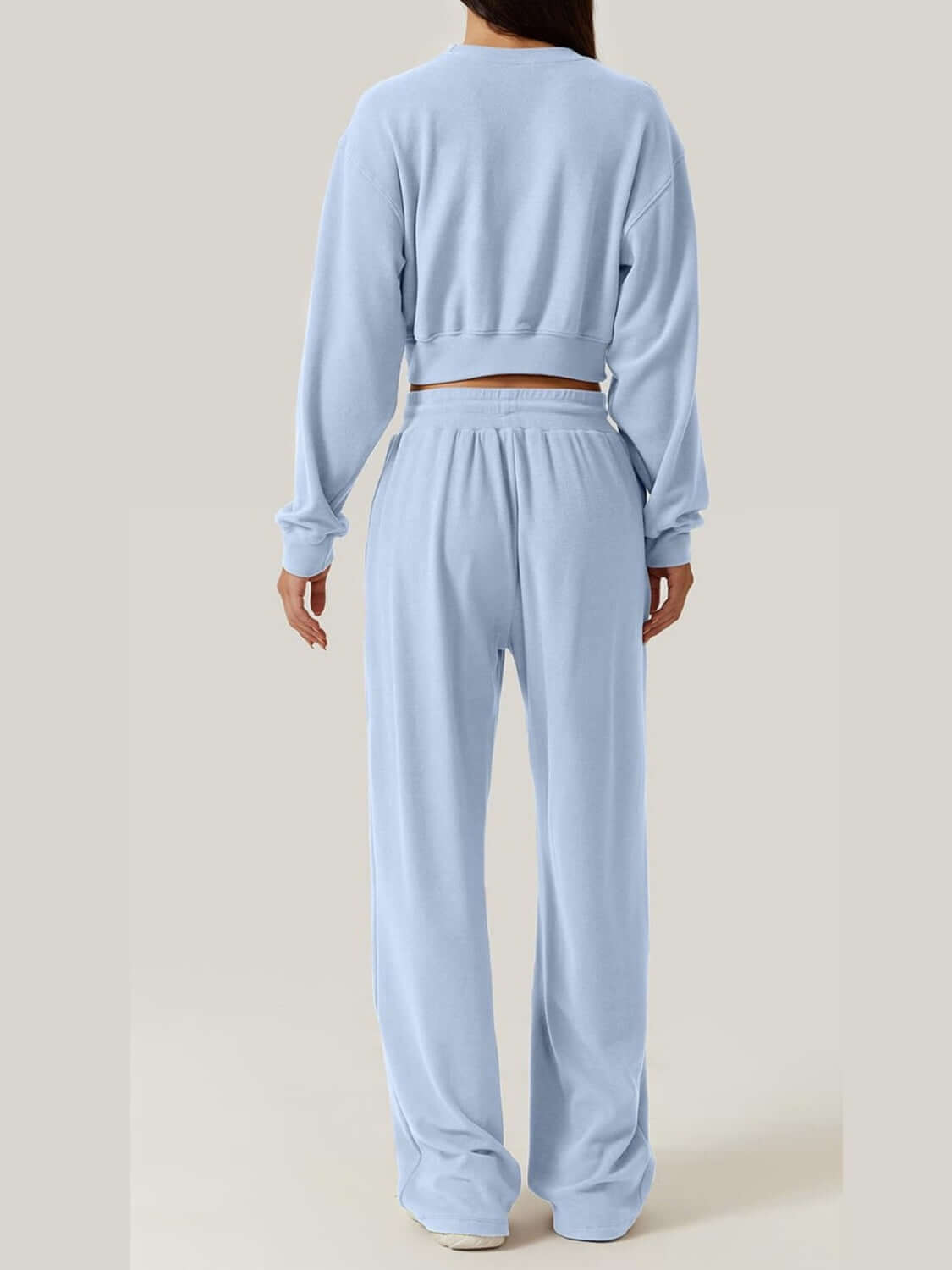 Back view of Bella Road Crisscross Round Neck Top and Drawstring Pants Set in light blue, showcasing the full outfit from behind.