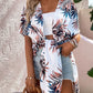 Stylish woman in Bella Road Swim cover up featuring a vibrant Birds of Paradise print, perfect for beach days or poolside lounging.