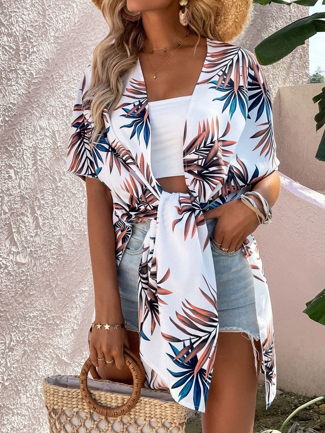 Stylish woman in Bella Road Swim cover up featuring a vibrant Birds of Paradise print, perfect for beach days or poolside lounging.