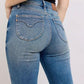 Back view of Judy Blue mid-rise tummy control vintage wash jeans showcasing a flattering fit and retro style.