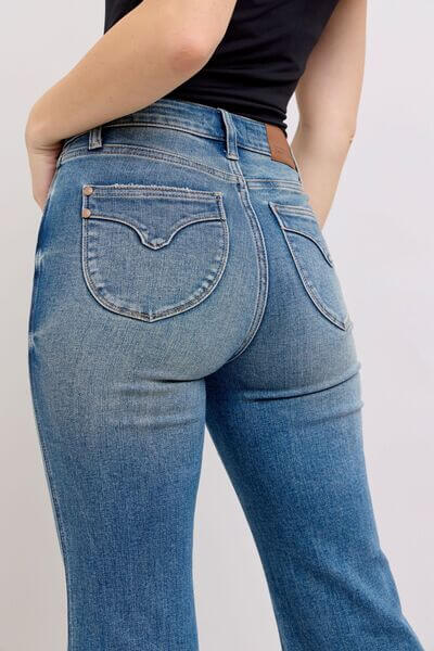 Back view of Judy Blue mid-rise tummy control vintage wash jeans showcasing a flattering fit and retro style.