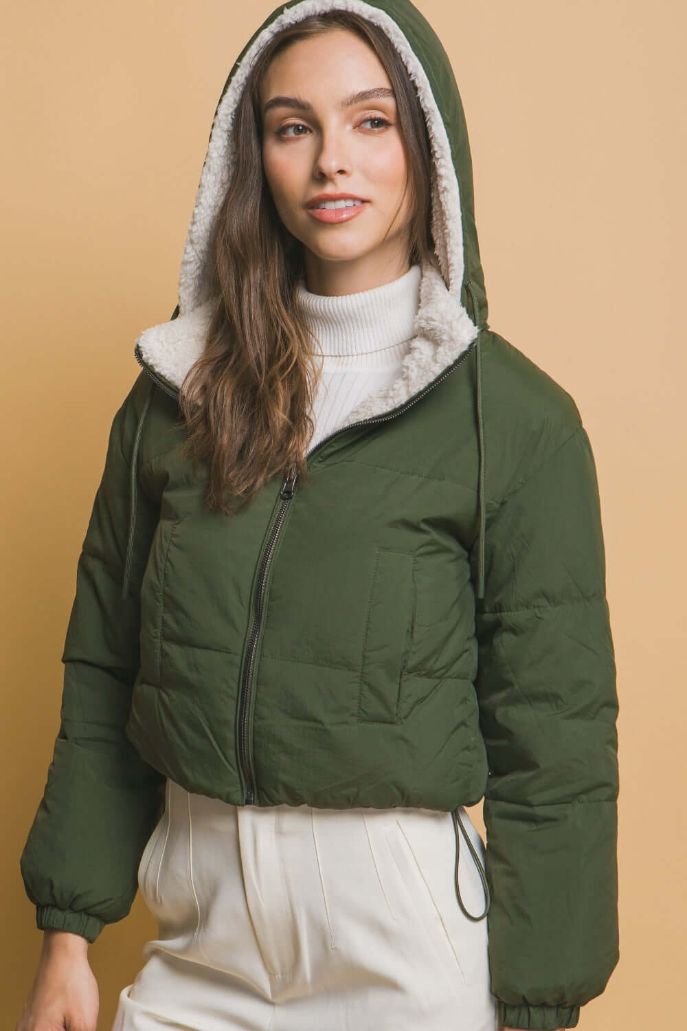 Woman modeling Love Tree Zip Up Cropped Hooded Sherpa Reversible Jacket in green, showcasing cozy and stylish winter fashion.