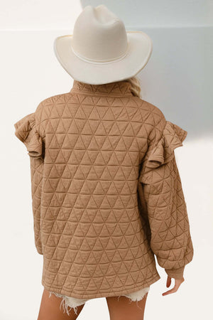 Woman wearing a ruffled texture half zip sweatshirt in camel, paired with a white hat, showcasing the cozy and stylish pullover.