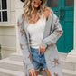 Woman in Angel Wings Star Cardigan, rocking a playful look with shorts and hat—cozy vibes with a dash of whimsy!