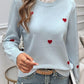 Woman wearing a Devine Lace Detail Heart Long Sleeve Sweater in light blue with red heart detailing and a lace collar.