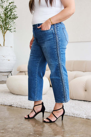 Wide leg jeans with braid side detail by Judy Blue Jeans styled with black high heels.