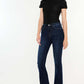 Woman wearing Kancan High Rise Slim Flare Jeans, dark stone wash denim with a sleek fit, paired with a black top and heels.