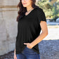 Woman wearing Basic Bae Bamboo Full Size V-Neck Short Sleeve T-Shirt in black, standing outdoors