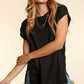 Woman wearing Pocketed Round Neck Cap Sleeve Knit Top in black paired with denim shorts, showcasing a casual and elegant look