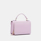 Nicole Lee USA small crossbody wallet in vegan leather with handle and front compartment, shown in light pink color.