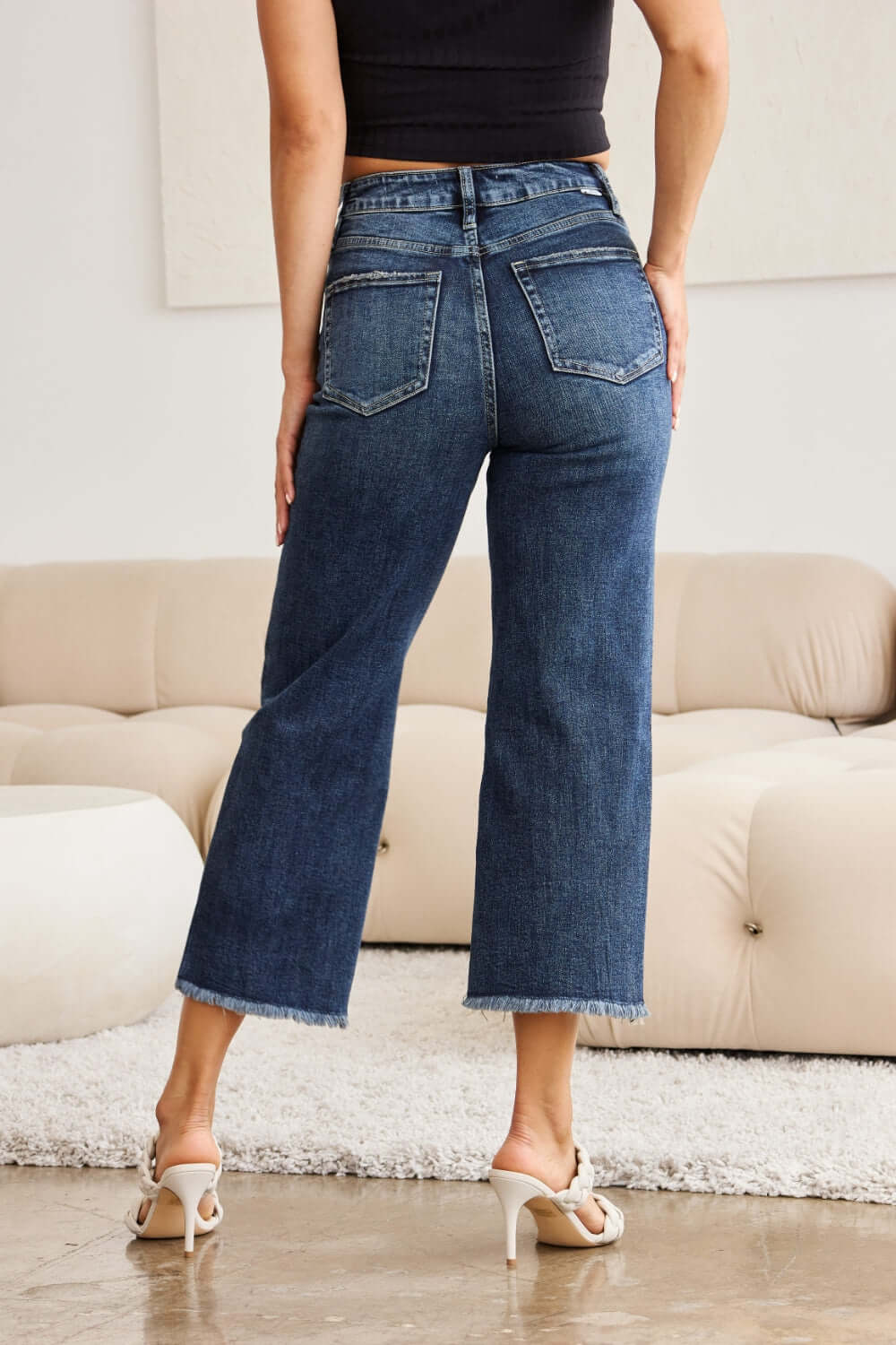 Woman wearing Tummy Control High Waist Raw Hem RFM Jeans for a stylish and flattering look