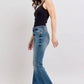 Woman in black tank top wearing Judy Blue tummy control vintage wash jeans, showcasing a chic side view in a stylish pose.