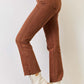 High Rise Tummy Control Straight Jeans by Risen Jeans with raw hem detail, side view in brown, paired with white ankle boots