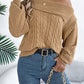 Woman wearing Bella Road Cable-Knit One Shoulder Long Sleeve Sweater in beige, paired with jeans and accessories, standing in stylish setting.