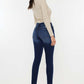 Woman modeling Mid Rise Gradient Skinny Jeans, showcasing the sleek and slimming fit of the trendy denim, perfect for a stylish look.