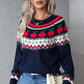 Woman wearing Angel Wings Graphic Sweater with apple pattern, round neck, and long sleeves, paired with jeans and sunglasses.