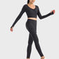 Model showcasing the Millennia Ruched Cropped Long Sleeve Sports Top in black, paired with matching leggings and sporty sneakers.