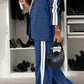 Stylish woman in a blue denim two-piece set with contrast lapel and striped details, showcasing modern fashion trends.