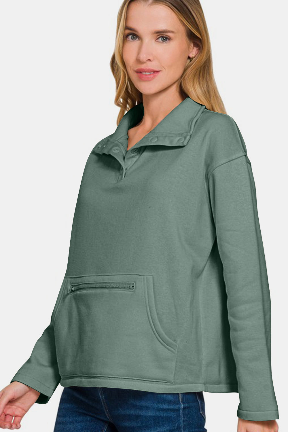 Stylish woman wearing a green Zenana Turtleneck Half Snap Fleece Sweatshirt, showcasing cozy comfort and sporty style.