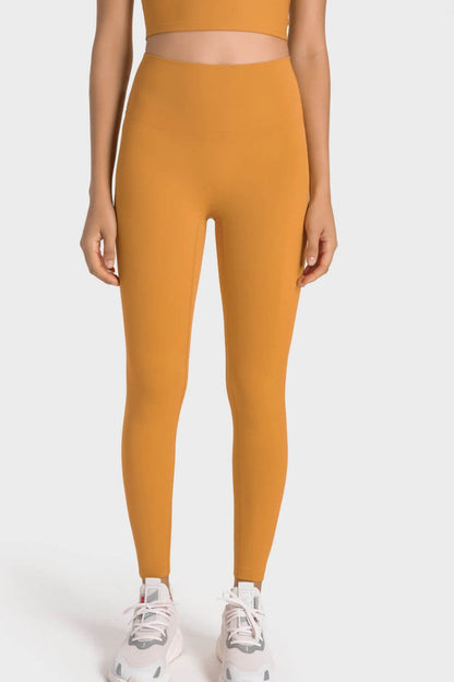 Millennia High-Rise Wide Waistband Yoga Leggings in mustard color, showcasing a sleek, comfortable fit for yoga practice.