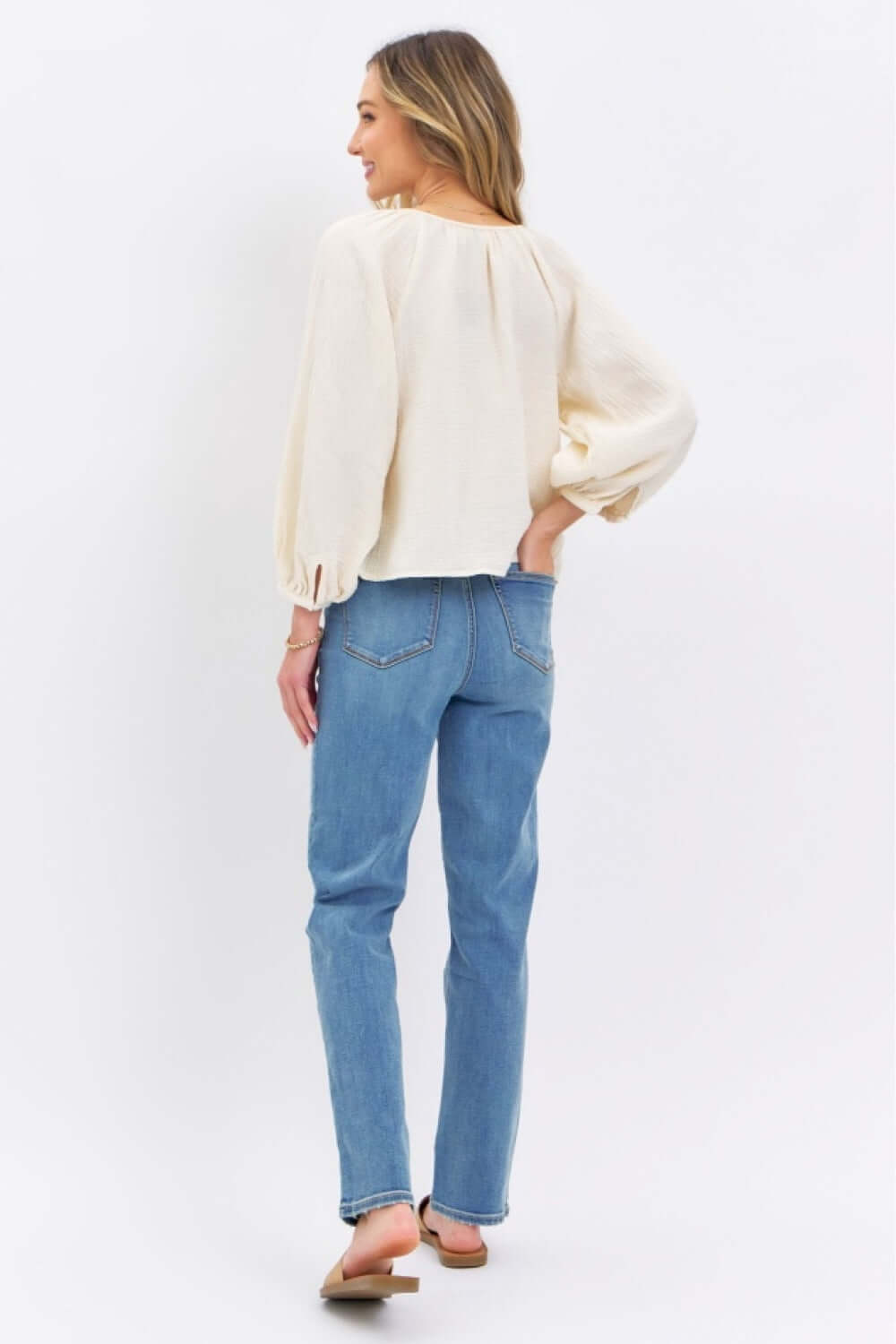 Woman wearing Judy Blue high waist straight jeans with casual blouse in light room.