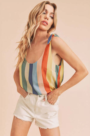 Model wearing Aemi + Co striped scoop neck tank top with tie shoulder detail and white shorts.