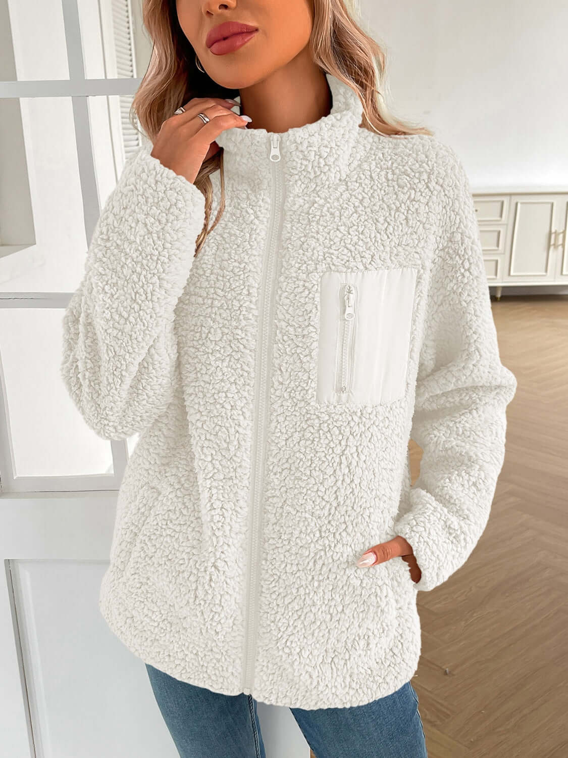 Woman wearing Ivy Lane Zip Up Long Sleeve Fuzzy Jacket in white, cozy and stylish for chilly days.