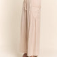 Beige smocked waist boho wide leg pants with pockets, showcasing relaxed fit and style for casual or dressy occasions.