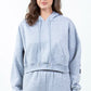 Trendy gray cropped hoodie with drawstring detail and casual style, perfect for a laid-back urban look.