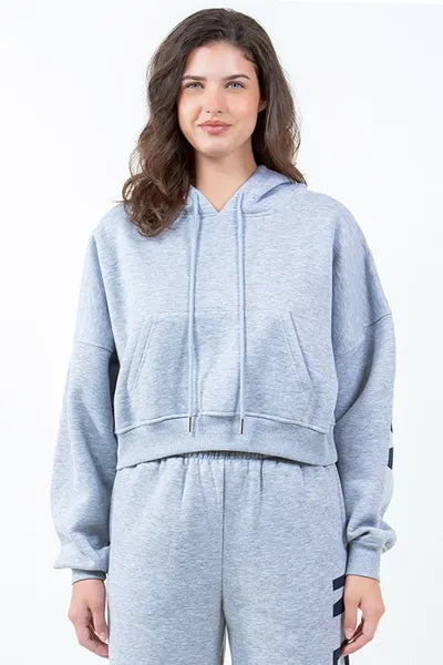 Trendy gray cropped hoodie with drawstring detail and casual style, perfect for a laid-back urban look.