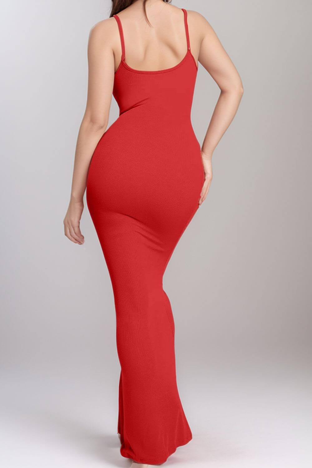 Woman wearing a red Basic Bae Built-In Shapewear Sleeveless Maxi Dress, highlighting curves and sleek silhouette from the back.