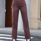 Stylish woman in dark brown straight leg jeans, perfect for casual outings or road trips, paired with trendy sneakers.