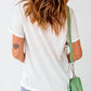 Woman wearing Bella Road THANKFUL round neck short sleeve t-shirt with slightly stretchy fabric, shown from behind with green purse.