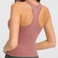 Model showcasing the back of the Millennia Round Neck Racerback Active Tank in rose color, perfect for workouts.