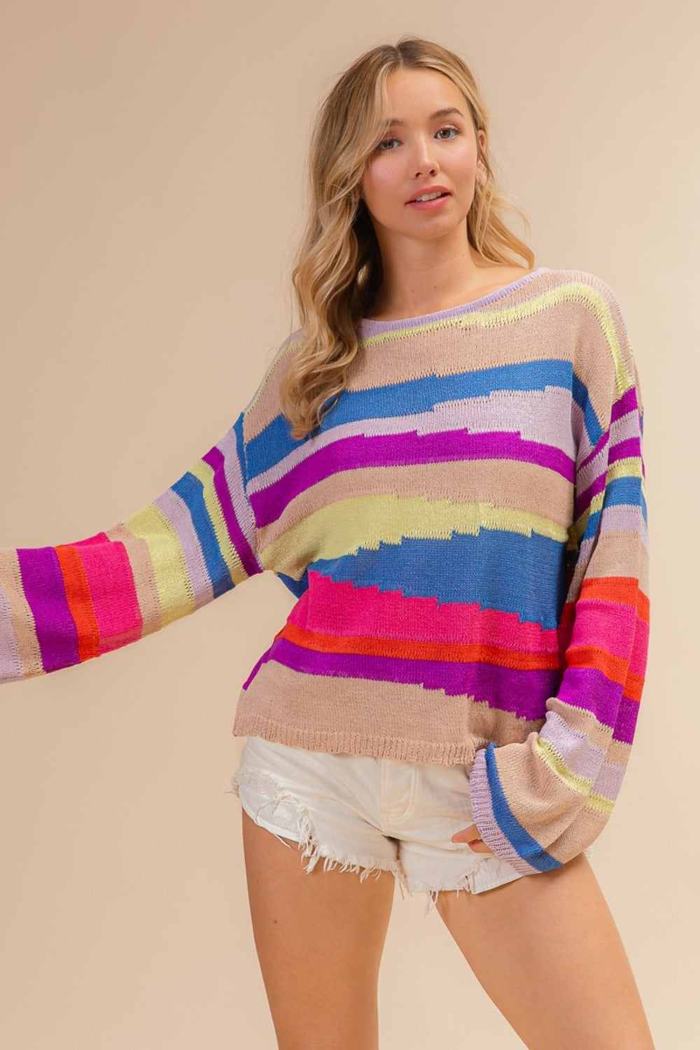 Woman wearing BiBi Multi Color Geometric Stripe Sweater in vibrant knit, showcasing chic modern design perfect for cooler days.