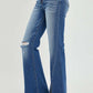 High Rise Front Slit Frayed Hem Flare Jeans by Risen Jeans, trendy and stylish with a flattering fit and edgy front slit for casual outings.