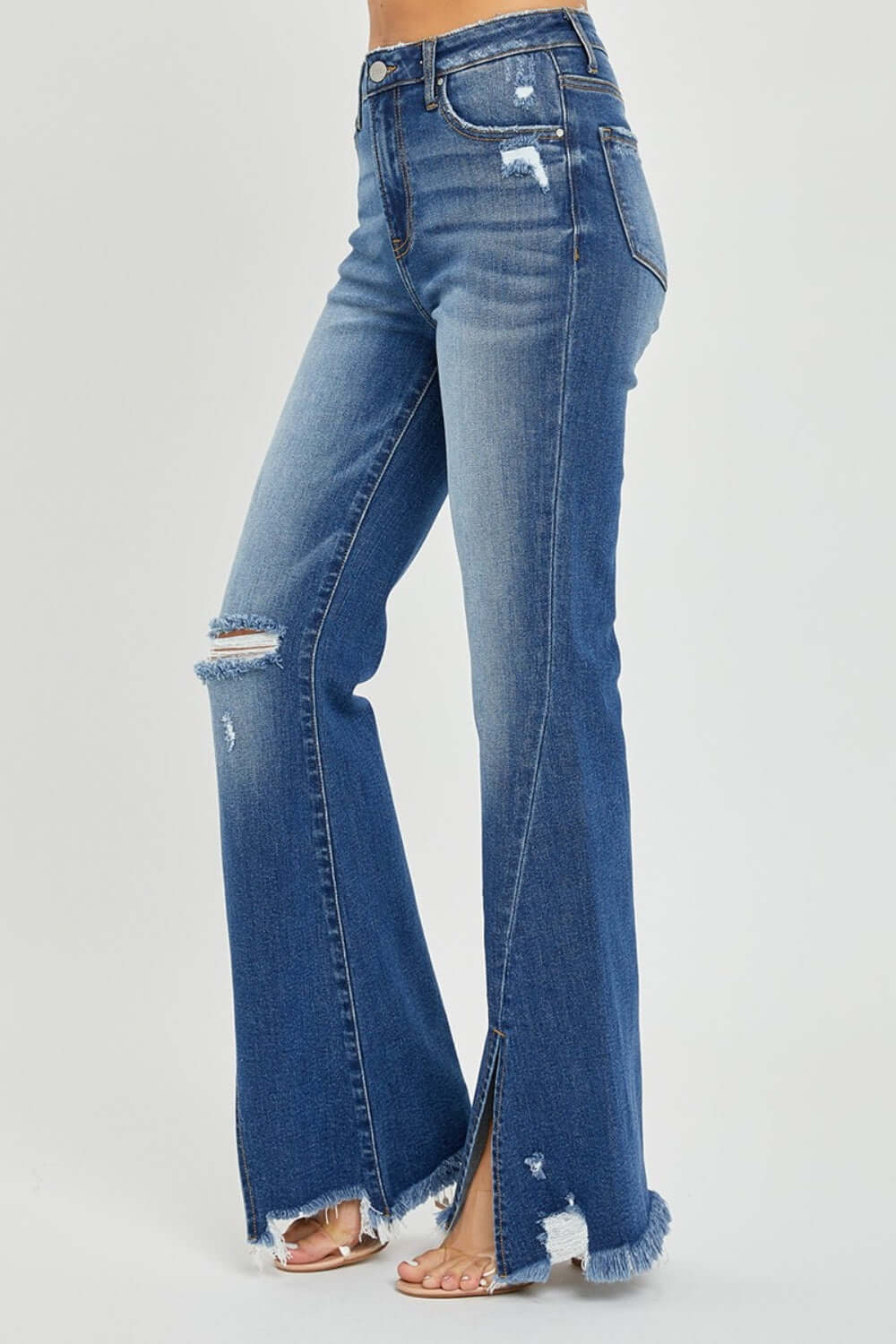 High Rise Front Slit Frayed Hem Flare Jeans by Risen Jeans, trendy and stylish with a flattering fit and edgy front slit for casual outings.